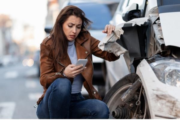 Woman takes pictures of car accident