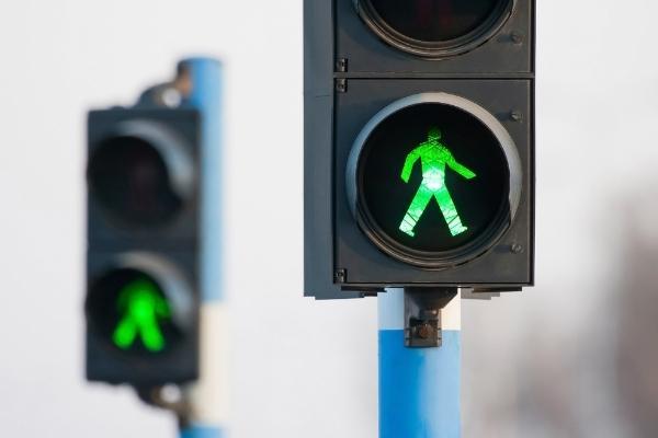 pedestrian crosses during green light and is hit by car